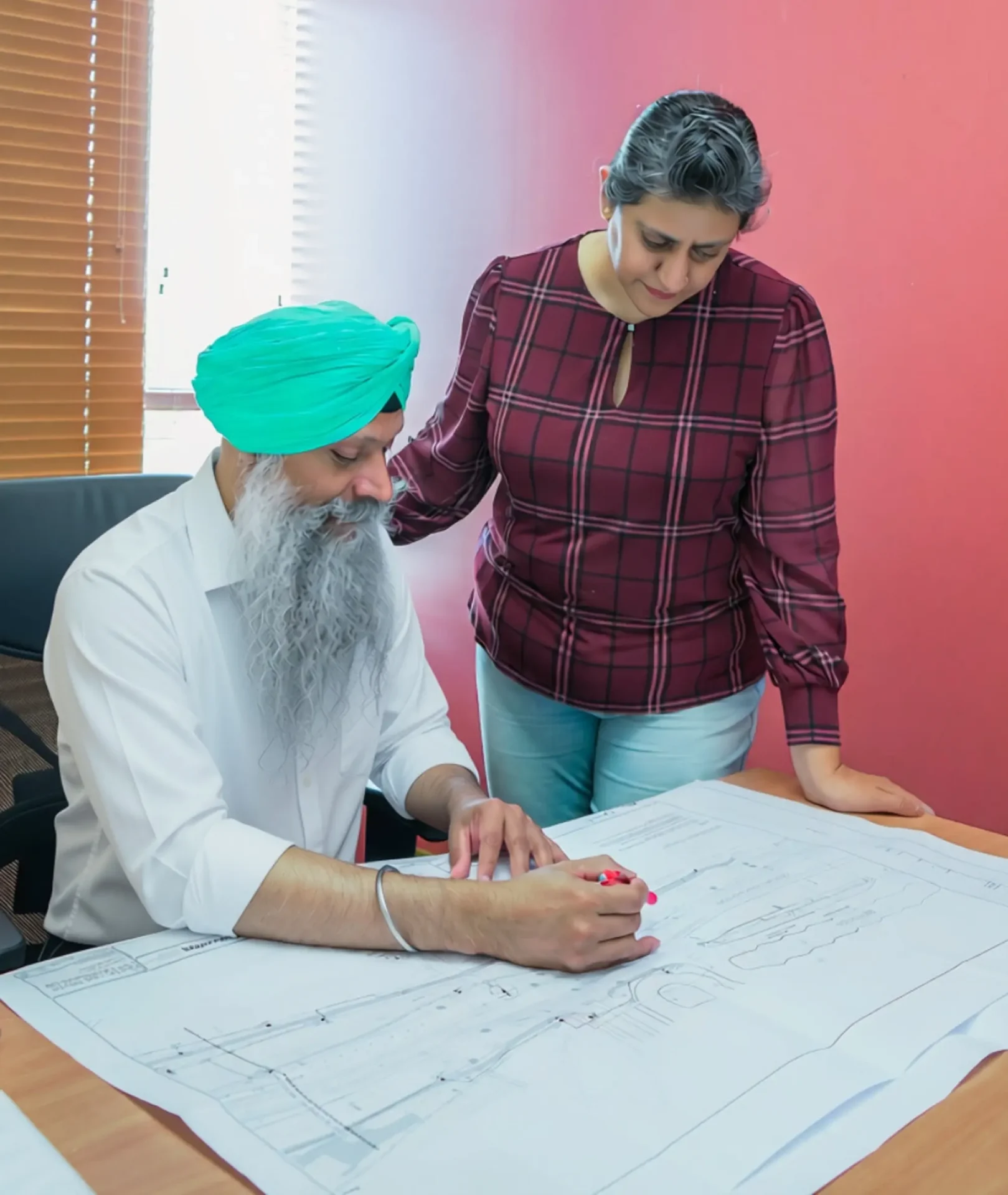 Two people reviewing architectural plans together.